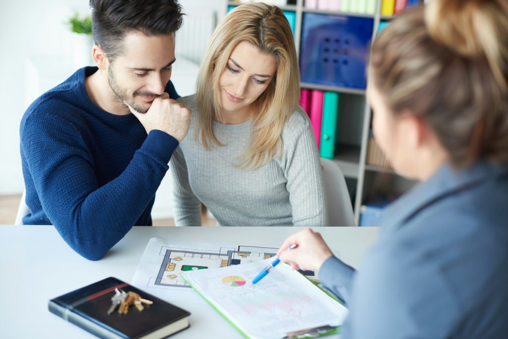 Couple visiting estate agents office